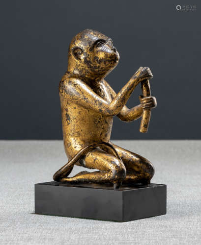A GILT- AND BLACK-LACQUERED BRONZE FIGURE OF A MONKEY