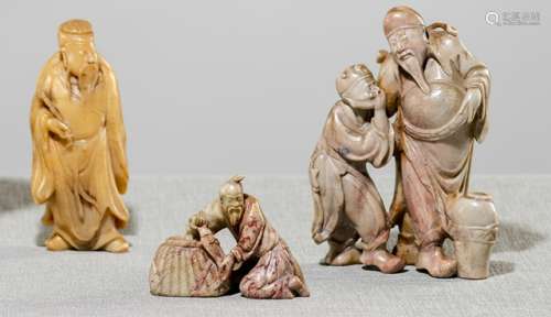 A GROUP OF THREE CARVED SOPASTONE FIGURES