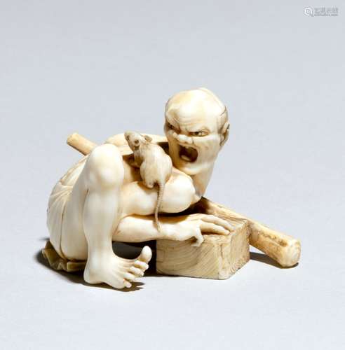 A WELL CARVED IVORY NETSUKE OF A RAT CATCHER