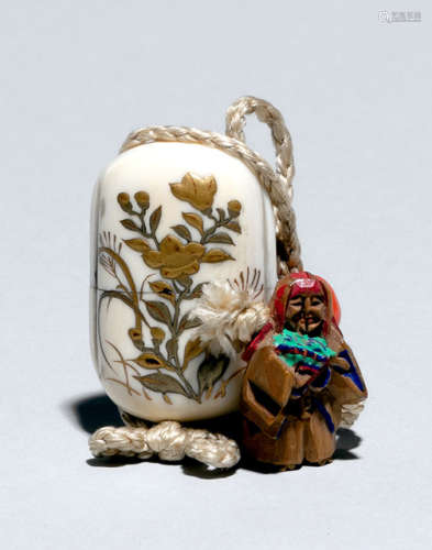 AN IVORY MINIATURE INRO WITH GOLD LACQUERED FLORAL DECORATION AND CARVED WOOD OJIME OF SHOJO HOLDING A FAN