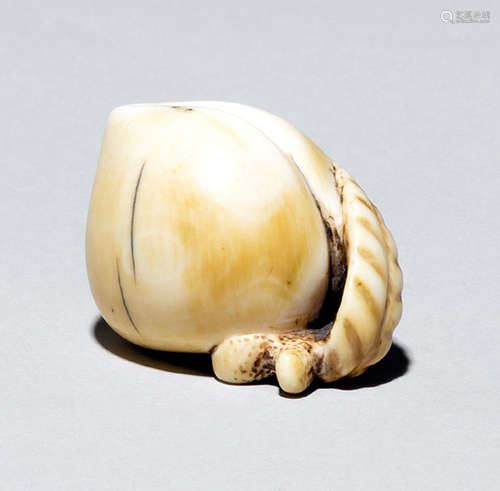 A CARVED IVORY NETSUKE IN A SHAPE OF A PEACH