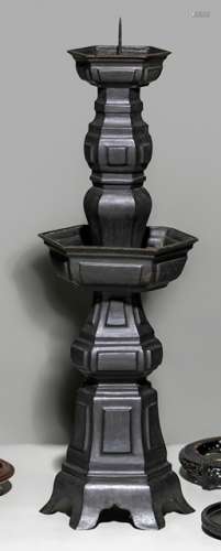 A LARGE PATINATED BRONZE CANDLE HOLDER
