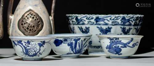 A GROUP OF ONE FOLIATE-RIMMED AND THREE SMALLER BLUE AND WHITE BOWLS