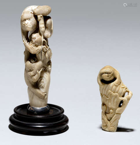 A CARVED IVORY OKIMONO OF A GROUP OF MONKEYS AND A STAGANTLER NETSUKE OF A TANUKI ATOP A TREE TRUNK