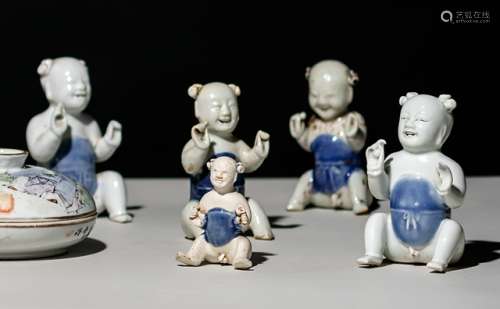 A GROUP OF FIVE PORCELAIN 'CARGO' FIGURES OF SEATED BOYS