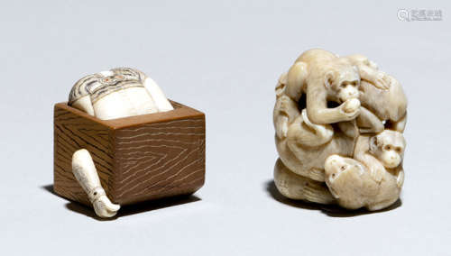 AN IVORY OKIMONO OF A GROUP OF MONKEYS AND AN IVORY/WOOD NETSUKE OF AN ONI IN A BOX