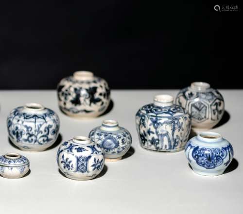 A GROUP OF TEN SMALL BLUE AND WHITE JARS