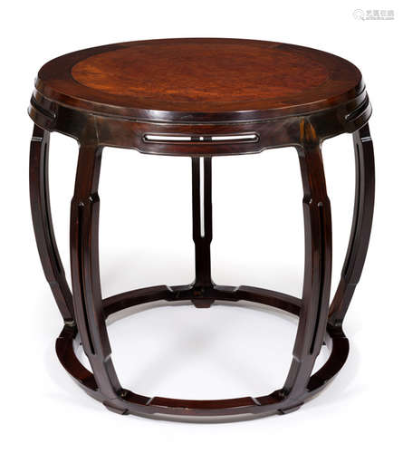 A ROUND HARDWOOD TABLE