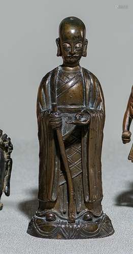 A BRONZE FIGURE OF A MONK