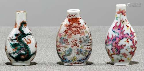 A GROUP OF THREE POLYCHROME DECORATED DRAGON OR PHOENIX PORCELAIN SNUFFBOTTLES