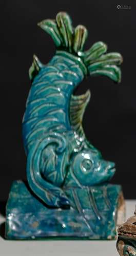 A TURQUOISE-GLAZED FISH-SHAPED ROOF TILE