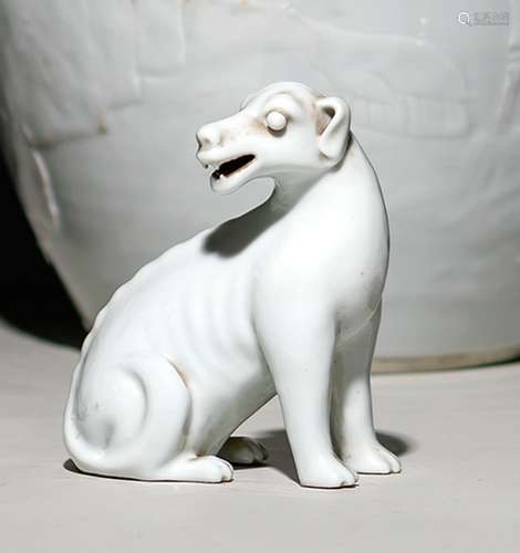 A WHITE GLAZED PORCELAIN DOG