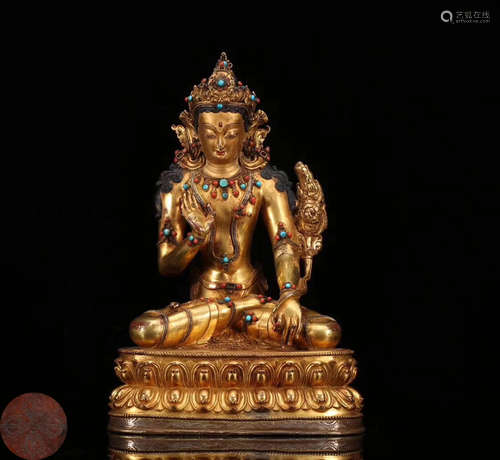 A GILT BRONZE MOLDED BUDDHA STATUE