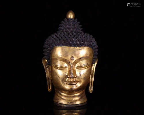 A GILT BRONZE TIBETAN SHAKYAMUNI HEAD STATUE