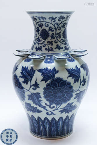 A BLUE AND WHITE FLORAL SHAPED VASE WITH MARK