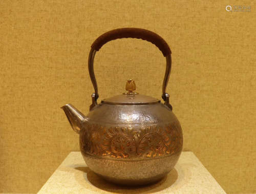 A SILVER LIFTING TEAPOT