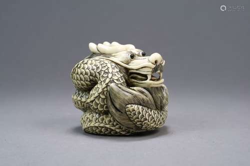 A Japanese Ivory Okimono of a Dragon