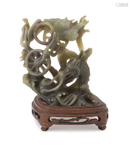 A CHINESE SERPENTINE SCULPTURE, 20TH CENTURY. representing a dragon surrounded by mighty flames