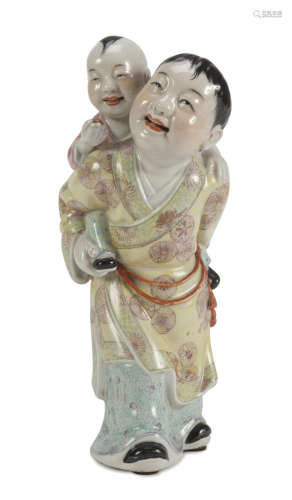 A CHINESE POLYCHROME PORCELAIN GROUP, 20TH CENTURY representing a Taoist divinity that supports a