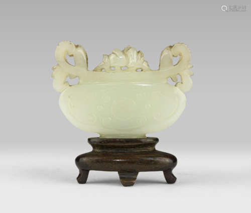 A JADE SCULPTURE, CHINA, EARLY 20TH CENTURY representing a composition of peonies in decorated