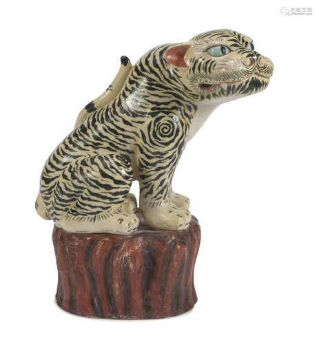 A CHINESE POLYCHROME PORCELAIN SCULPTURE, 20TH CENTURY. representing a mighty tiger on rocky base.