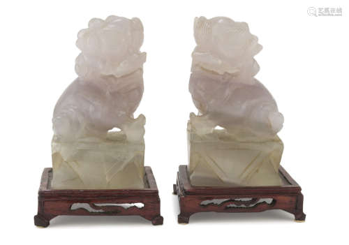 A PAIR OF CHINESE FLUORITE SCULPTURES, 20TH CENTURY. representing two Buddhist lions in protective