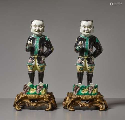 A RARE PAIR OF FAMILLE NOIRE FIGURES OF FOREIGNERS, KAN…
