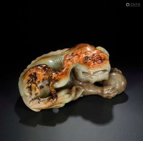 A LARGE CELADON AND RUSSET JADE ‘BUDDHIST LION’, 17th C…