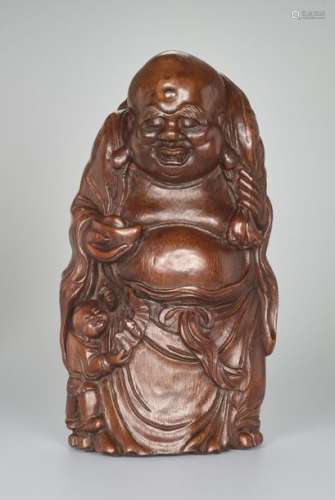 A VERY LARGE BAMBOO SHOOT CARVING OF BUDAI WITH INGOT, …