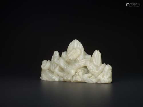 A CELADON JADE BRUSH REST WITH CONFRONTING DRAGONS AND …