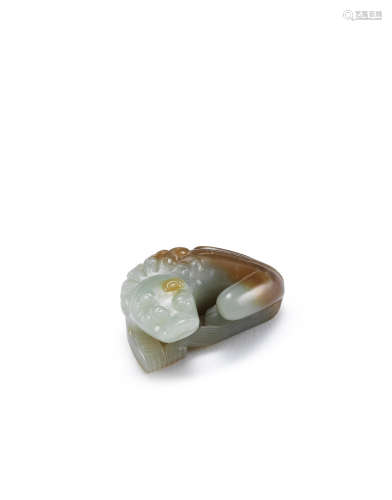 Yuan Dynasty or earlier A rare pale green and russet jade carving of a lion