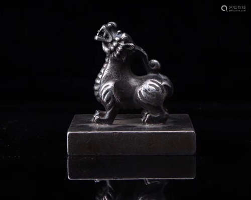 A SILVER LION SHAPED SEAL