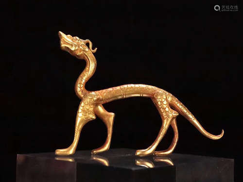 A GILT COPPER DRAGON SHAPED FIGURE