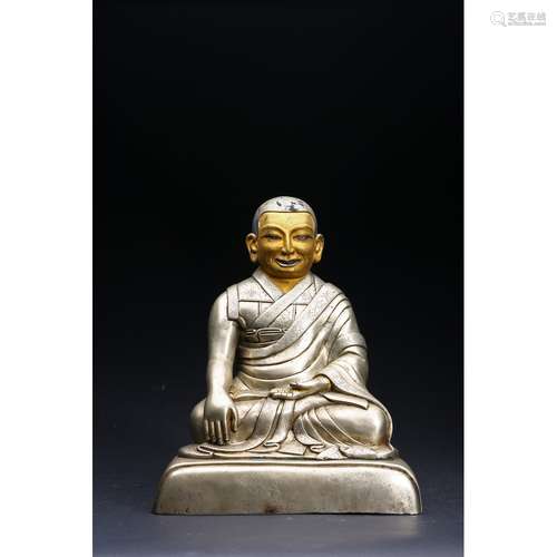 A SILVER FIGURE OF LAMA WITH COLD-GILT FACE