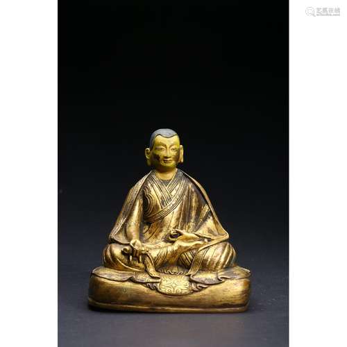 A CARVED GILT-BRONZE FIGURE OF LAMA