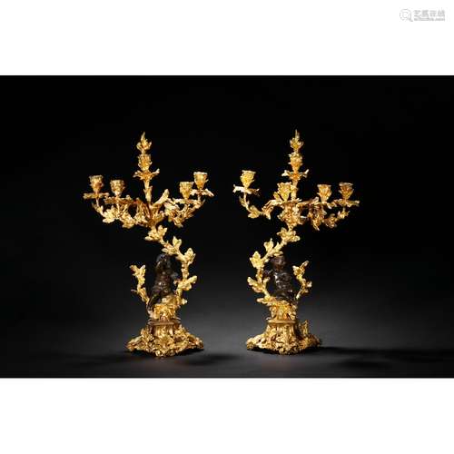 A PAIR OF LARGE EUROPEAN GILT CANDLESTICKS