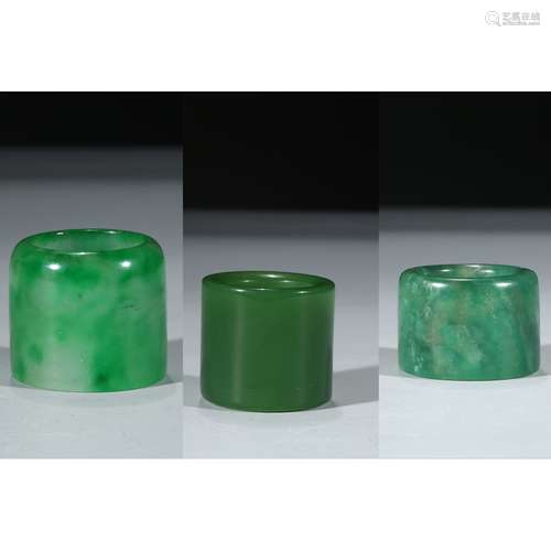 A GROUP OF THREE CARVED JADE ARCHER'S RINGS