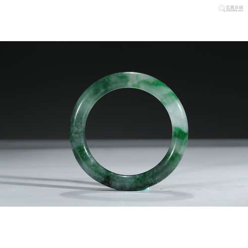 A JADEITE CARVED BANGLE