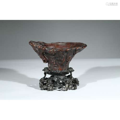 AN AGARWOOD CARVED LIBATION CUP WITH STAND