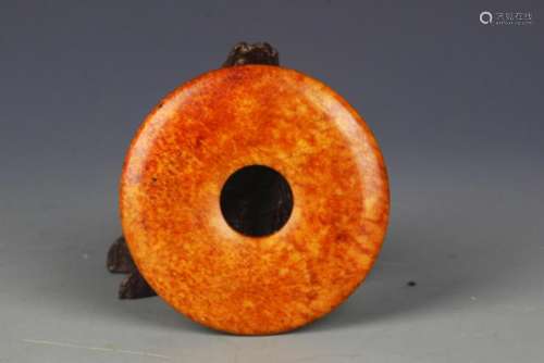 A FINELY CARVED OLD ROUND JADE