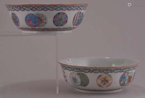 Pair of porcelain bowls. China. Early 20th century. Famille Rose decoration of brocade spheres and ju-i borders. Company mark on the base.  5-1/4