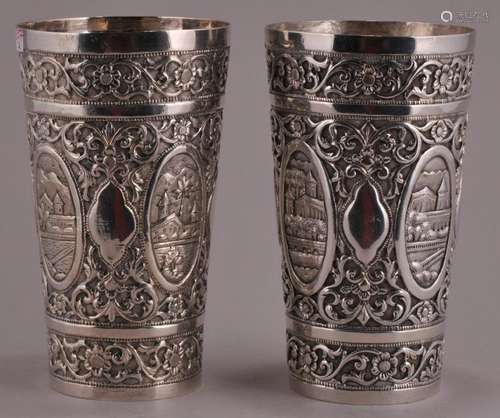 Two silver cups. India. 19th century. Repousse decoration of floral patterns with reserves of landscapes. 5-1/4