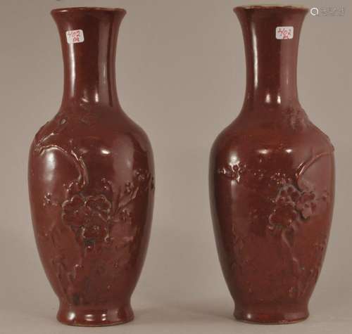 Pair of porcelain vases. China. Late 19th century. Oxblood glaze with moulded flowering trees. Artenesia leaf mark. Body cracks.   8