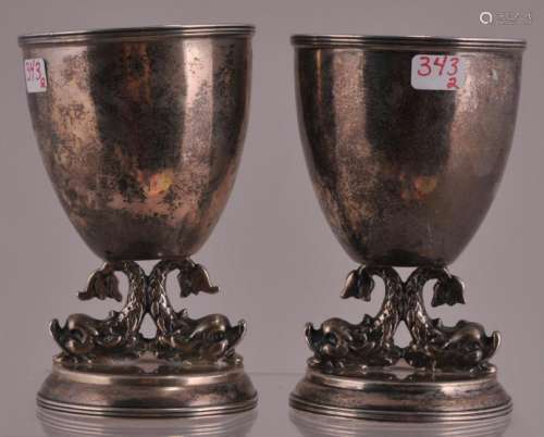 Pair of silver egg cups with dolphin bases.  Hallmarked at the mouth. 3-3/4