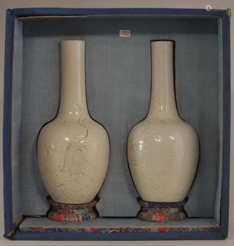 Pair of soft paste vases. China. Late 19th century. Hua shih yao. Bottle form. White crackled glaze with a moulded dragon.  Boxed. Vases only- 7-3/8