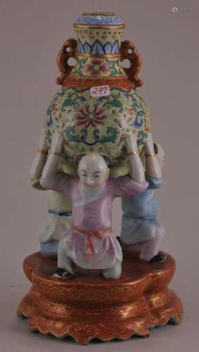 Porcelain vase. China. Late 19th century to early 20th century. Design of three boys with a vase on their shoulders. Ch'ien Lung mark on base.  8-1/4