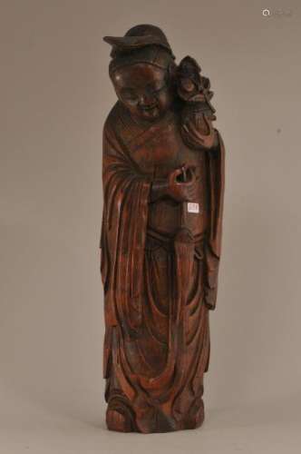 Bamboo carving. China. 19th century. Standing figure of an immortal holding a basket of flowers and a fly whisk.  13