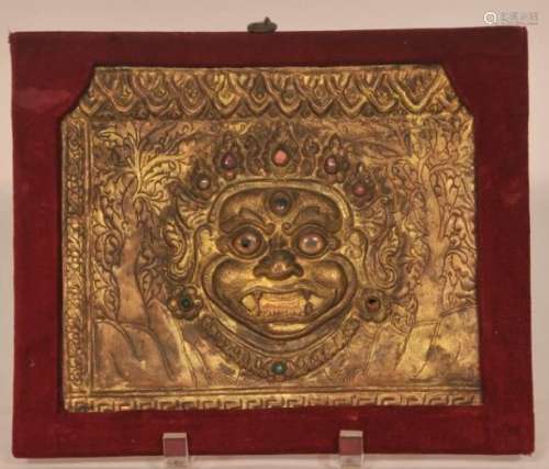 Repousse plaque. Nepal. Early 20th century. Image of Bhaivara inset with glass.  6-3/4