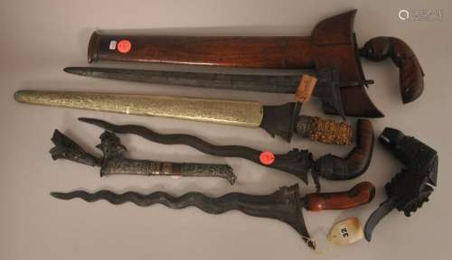Lot of assorted Kris and parts. Indonesia. 19th century. Five krisses and a king fisher kris belt. From the Estate of Jeanette Curuby.