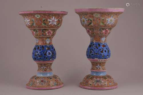 Pair of porcelain candle prickets. China. Ch'ien Lung mark but probably 20th century. Kuei Kung work with Fen Tsai colours. Decoration of stylized flowers on a tan ground. Chip to one.  10-1/2